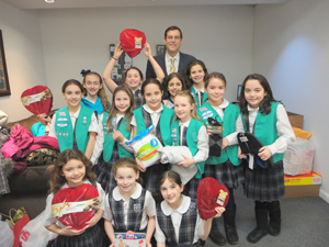 Assemblyman Edward C. Braunstein welcomed Sacred Heart Girl Scout Troop 4000 to his district office to accept their donations.