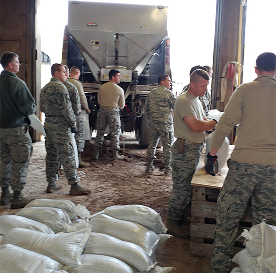 Members of the U.S. Army Corps of Engineers store sandbags for use along threatened areas of the Lake Ontario shoreline