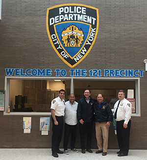 Assemblyman Steve Hawley (R,C,I-Batavia) and Assemblyman Michael Cusick (D-Staten Island) visit a local NYPD precinct on Staten Island and pose with local law enforcement members.