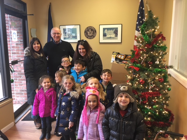 Assemblyman Dave McDonough (R,C,I-Merrick) is seen with children from the South Shore Country Day School and their teacher, Holly Kearney, who have donated toys for the past four years.
