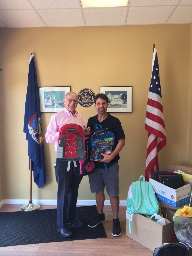 John Theissen [right] picks up donations of Assemblyman Dave McDonough's annual school supply drive.