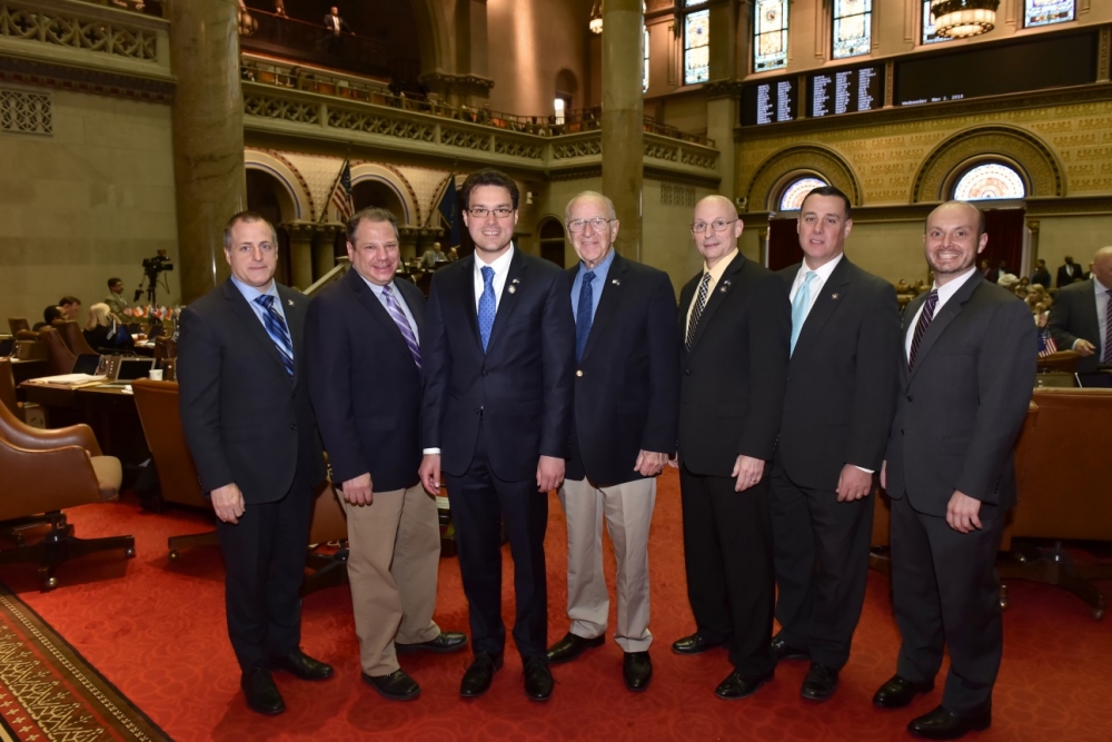 (Left to right): Assemblymen Brian Curran, Andrew Raia, John Mikulin, Dave McDonough, Dean Murray, Anthony Palumbo and Andrew Garbarino in the New York State Assembly Chamber during Mikulin's fir
