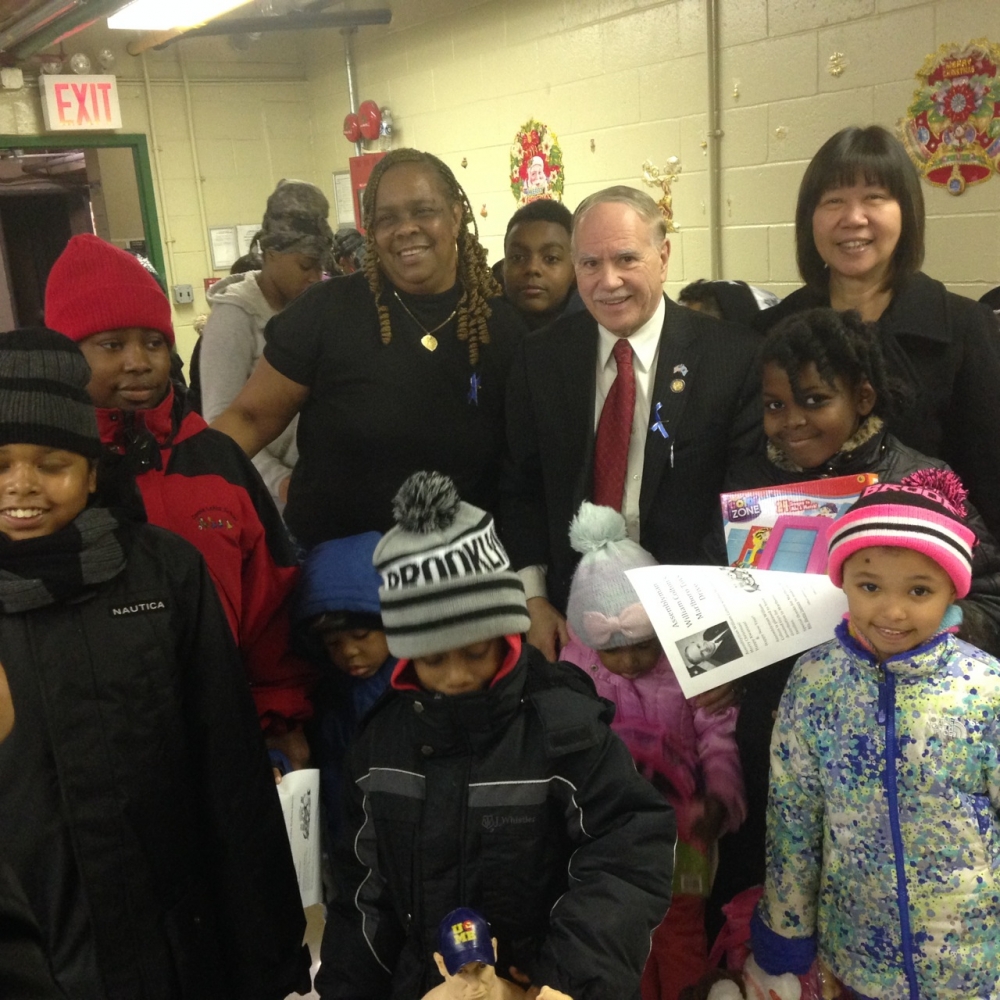 Assemblymember William Colton, Community Relations Director Nancy Tong with Marlboro Housing Residents Association President Betty James at a toy giveaway at Marlboro Housing.
