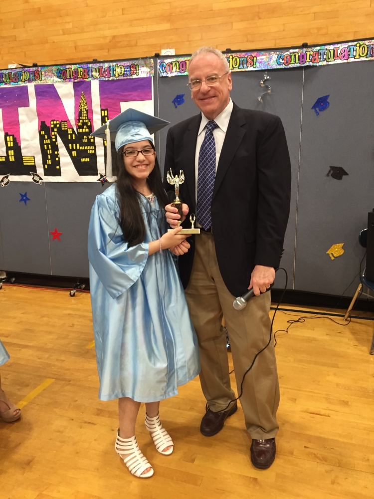 Assemblyman Dinowitz attending the June 23rd Graduation Ceremony of PS 307 and pictured here presenting the Community Service Award to Leandra Reyes.