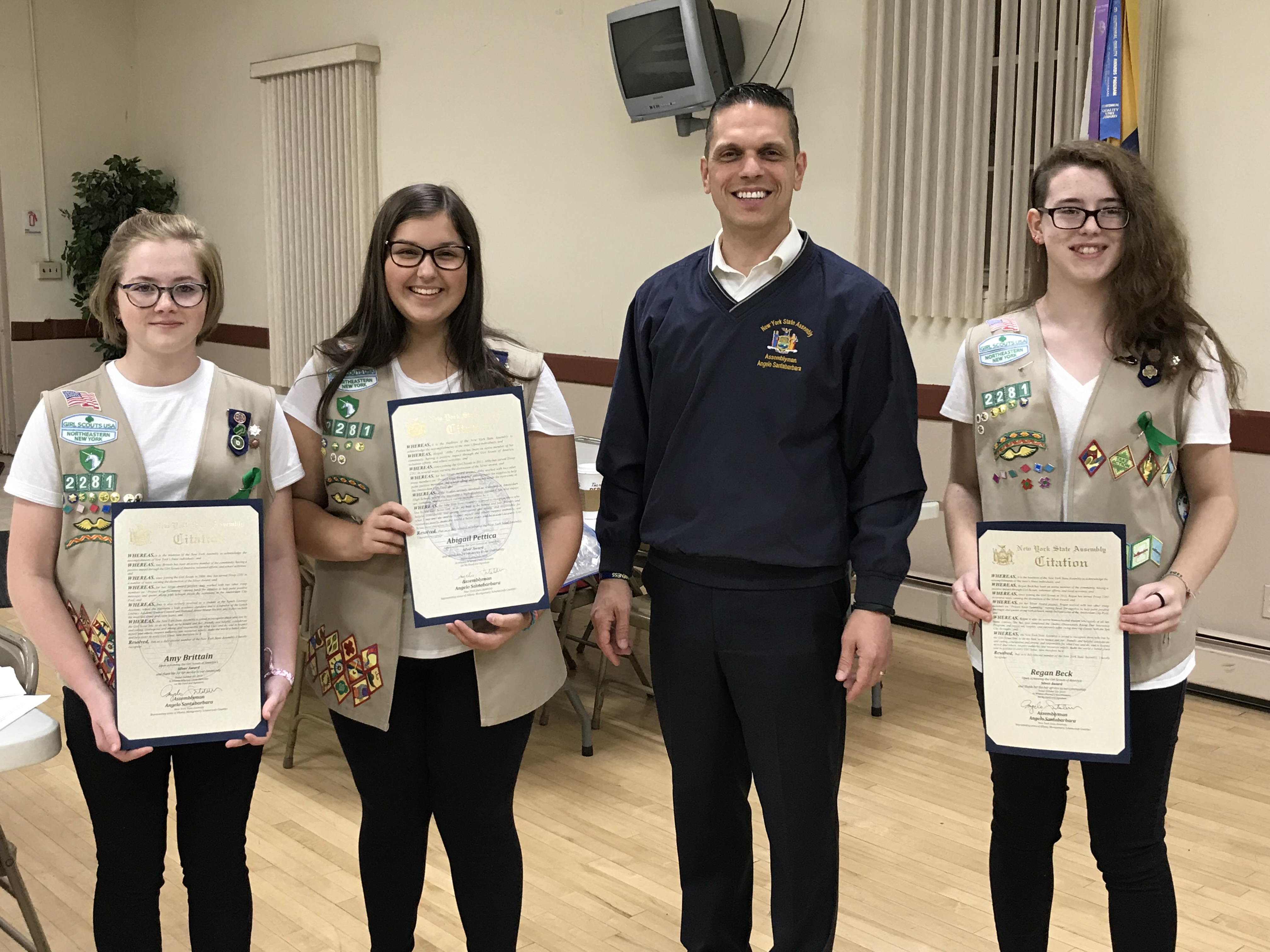 Assemblyman Angelo Santabarbara presents Amy Brittain, Abigail Pettica, and Regan Beck from Girl Scout Troop 2281 in Amsterdam with citations from the New York State Assembly recognizing their Silver