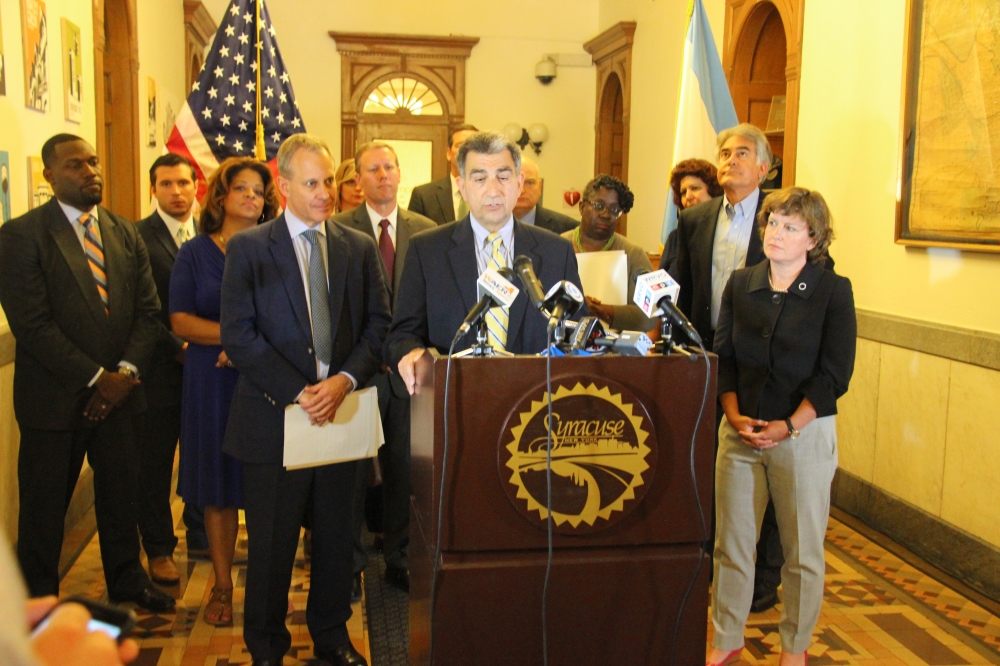 Assemblyman Magnarelli was part of an event celebrating the passage of legislation to prevent people from losing their homes through foreclosure and to address the problem of unoccupied and ill-mainta