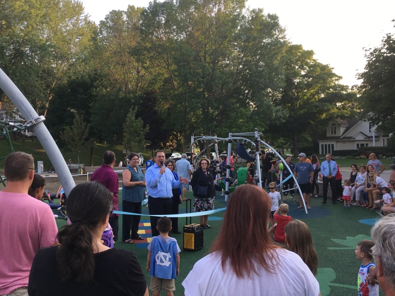 Assemblyman Ray Walter (R,C,I-Amherst) addresses attendees celebrating the ribbon cutting of ECO Park's new playground in Eggertsville on Tuesday, Aug. 15.