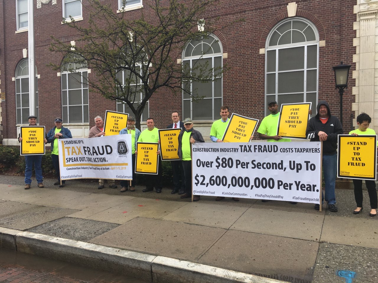 Assemblyman Karl Brabenec (R,C,I-Deerpark) [fifth from left] joins local officials and labor leaders for a rally to prevent wage theft and tax fraud in front of the Newburgh Post Office on Monday, April 15.