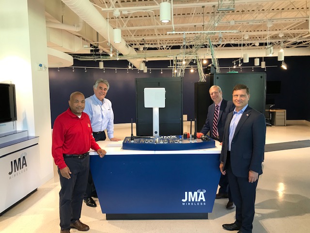 Pictured in the first photo with Speaker Heastie at JMA Wireless is (from left to right): Assemblymember Al Stirpe, Manufacturers Association of Central New York President and CEO Randy Wilkes and JMA Wireless owner John Mezzalingua.