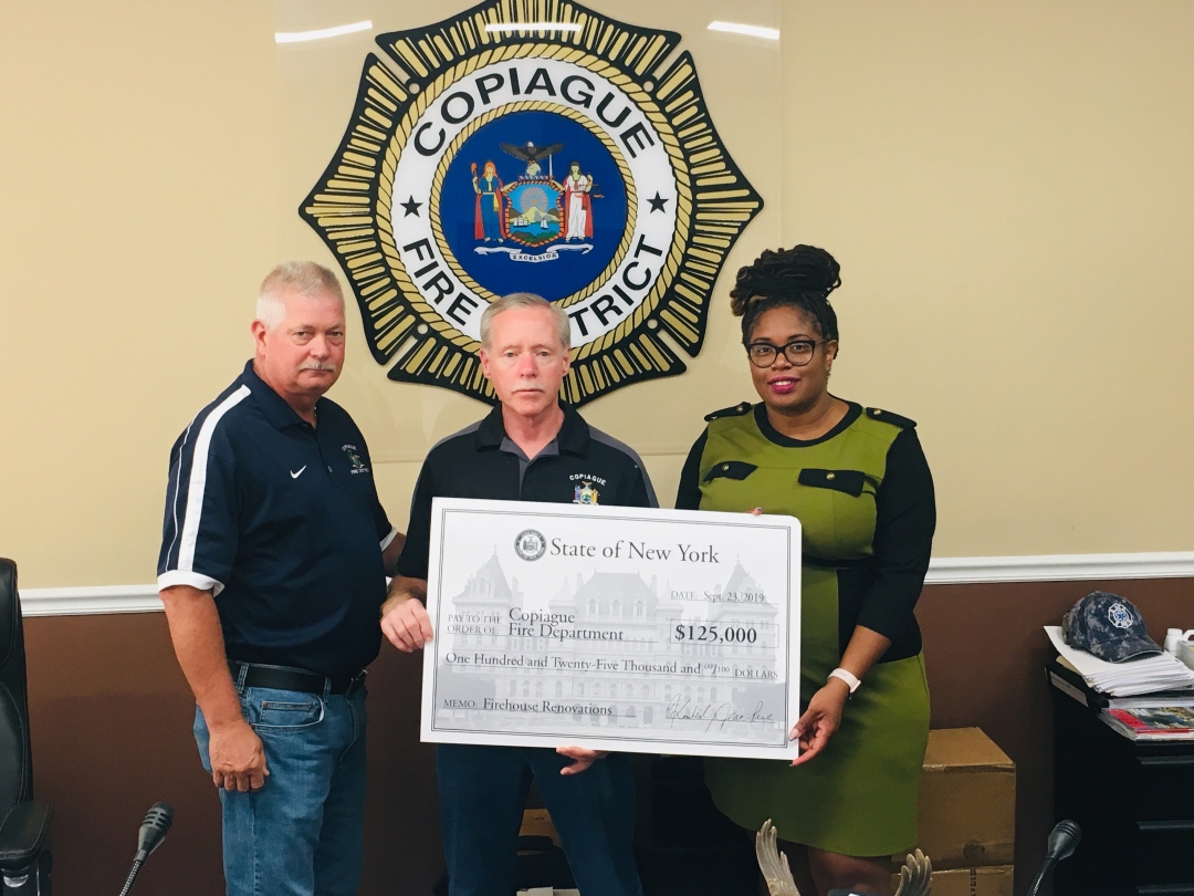 Pictured from left to right are Copiague Fire District Commissioner William Crothers, Jr., Vice Chairman Arthur Steigert, and Assemblywoman Jean-Pierre.