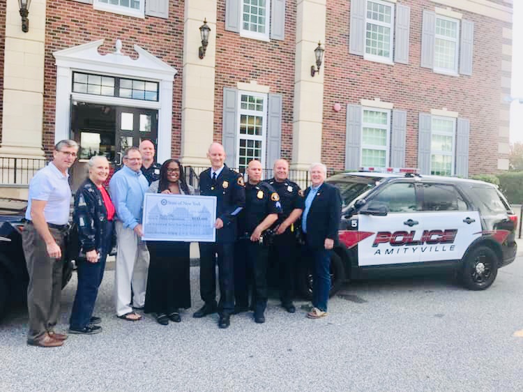 Assemblywoman Jean-Pierre is pictured with several members of the Amityville Village Police Department, Chief Glenn C. Slack, Amityville Village Mayor Dennis Siry, and Village Trustees Kevin Smith, Jessica Bernius, and Michael O’Neill.