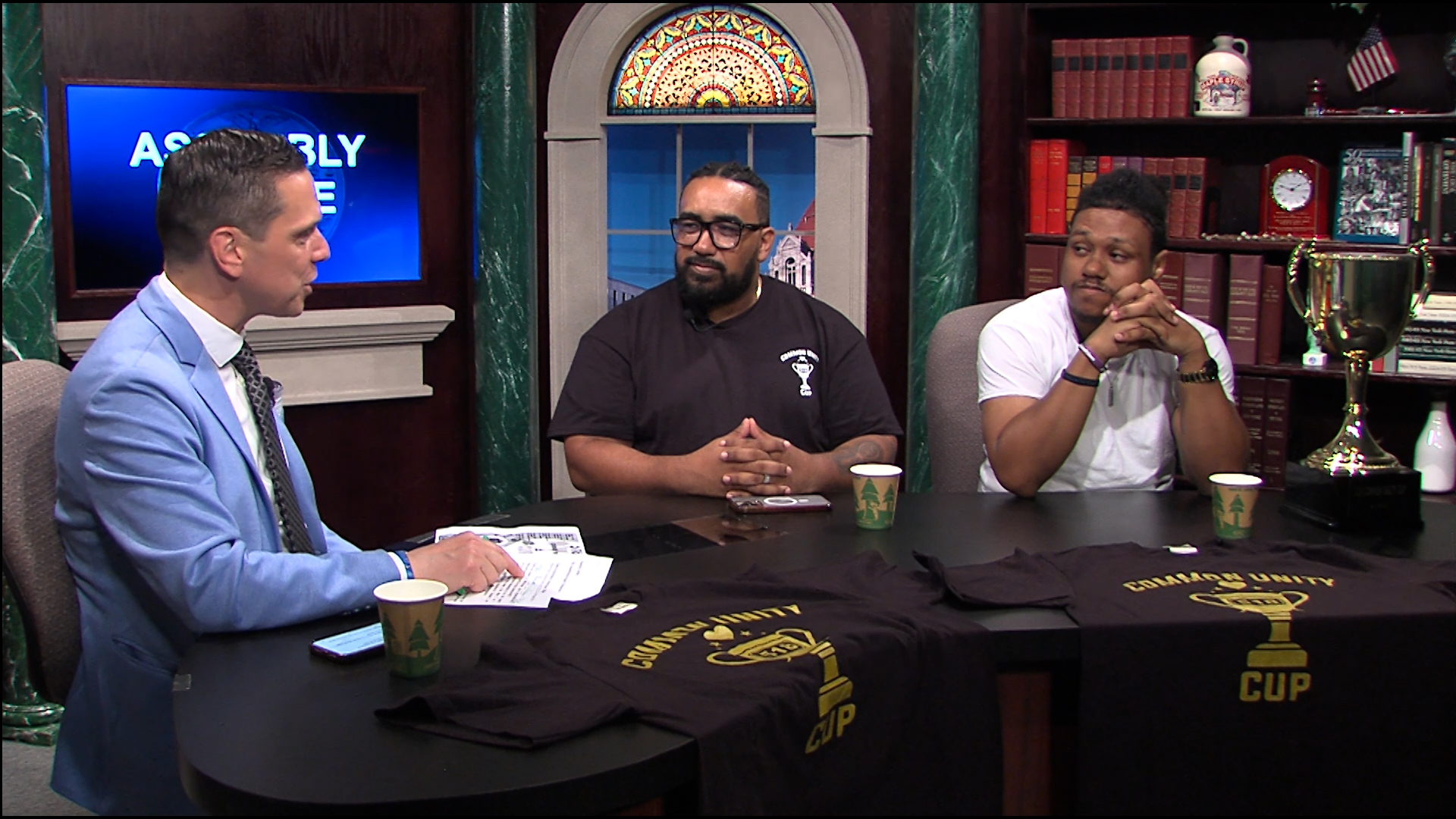 Assemblyman Santabarbara speaks with Will Revis and Adonis Richards from C.O.C.O.A House in Schenectady.